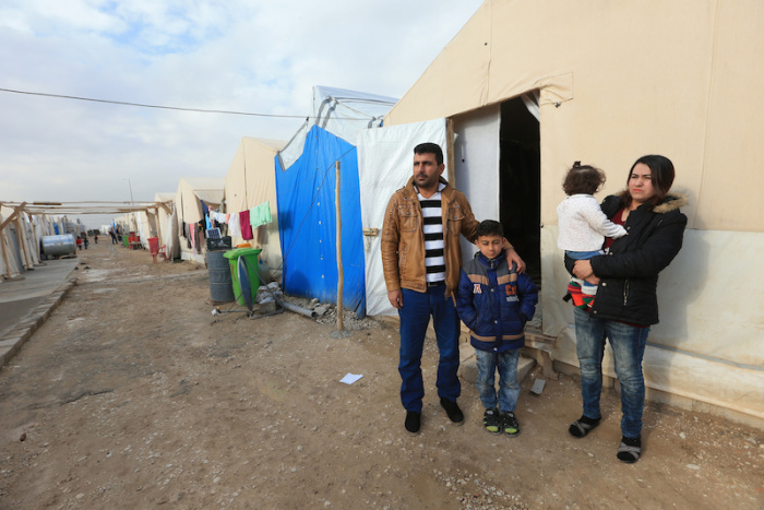 Khudeeda Rashowka Naif and his family, from a minority Yazidi community, stand outside a tent at a refugee camp near Duhok, Iraq, January 29, 2017. The family was getting ready to head to the airport but then they got the call from the international office of migration that their trip was off after U.S. President Donald Trump's decision to temporarily bar travelers from seven countries, including Iraq.