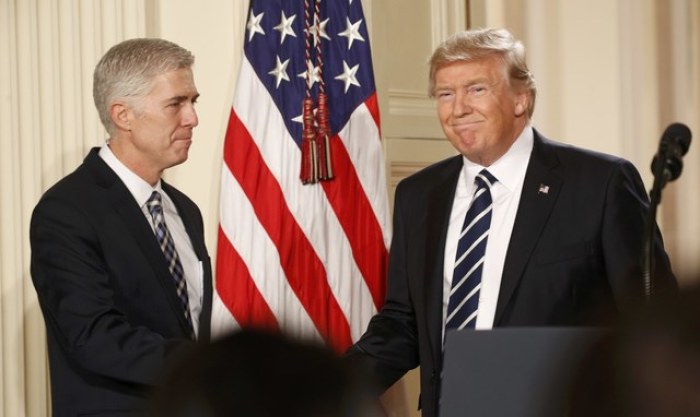 U.S. President Donald Trump shakes hands with Neil Gorsuch (L) after nominating him to be an associate justice of the U.S. Supreme Court at the White House in Washington, D.C., U.S., January 31, 2017.