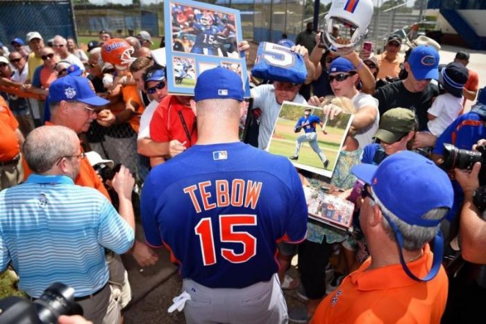 Tim Tebow signs autographs for fans after his workout at the Mets Minor League Complex.