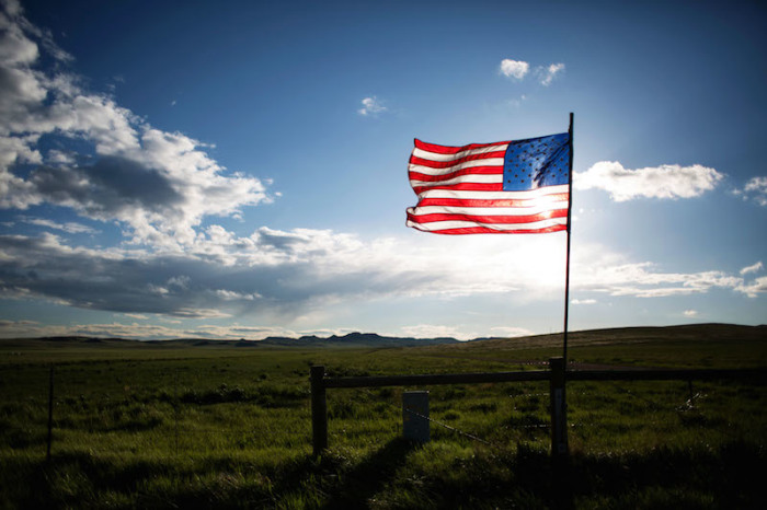 An American flag is seen along Wyoming Highway 59 near a residential housing development south of Gillette, Wyoming, U.S. May 31, 2016.