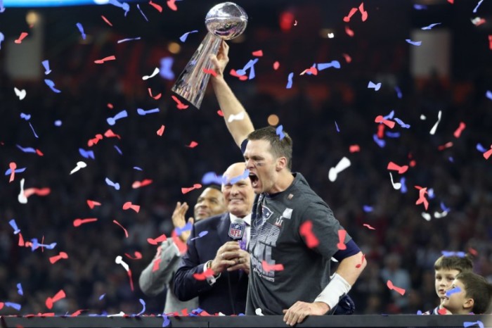 New England Patriots' quarterback Tom Brady holds the Vince Lombardi trophy as interviewer Terry Bradshaw approaches after his team defeated the Atlanta Falcons to win Super Bowl LI in Houston, Texas, U.S., February 5, 2017.