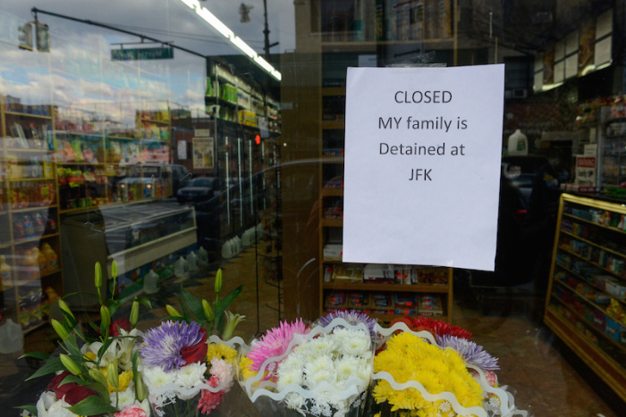A sign saying 'My family is detained at JFK' hangs in the window of a closed bodega during a Yemeni protest against President Donald Trump's travel ban, in the Brooklyn borough of New York City, U.S. February 2, 2017.