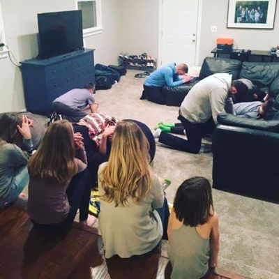 David and Jason Benham pray with their families and friends during the half-time show of Super Bowl 51, on February 5, 2017.