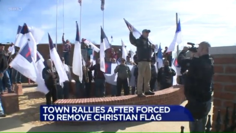 Residents of Rienzi, Mississippi gather to protest against the removal of a Christian flag from the town's veteran's memorial after the Wisconsin-based Freedom From Religion Foundation threatened legal action against the town's government on Feb. 4, 2017.