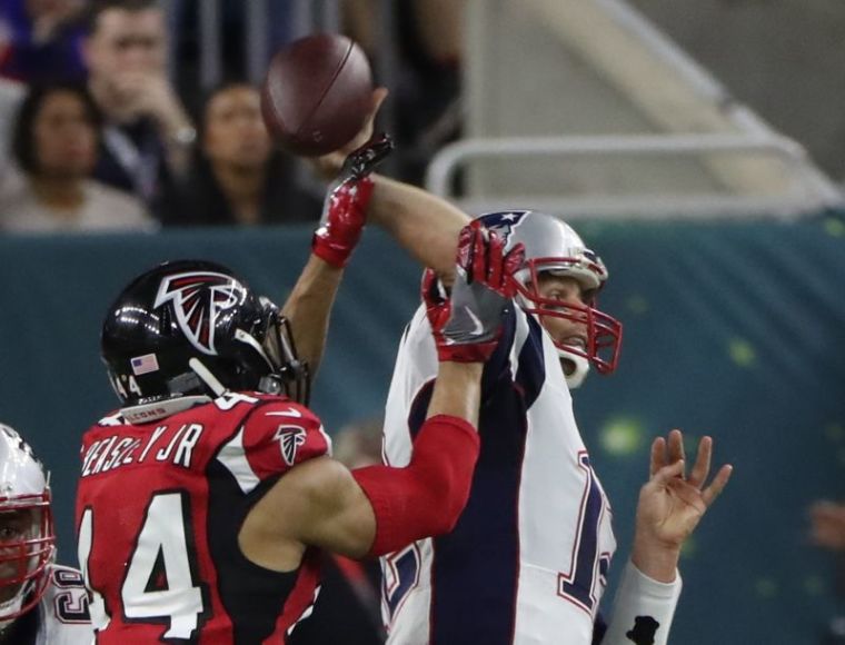 Atlanta Falcons' Vic Beasley (L) puts pressure on New England Patriots' quarterback Tom Brady during the second quarter of Super Bowl LI in Houston, Texas, February 5, 2017.