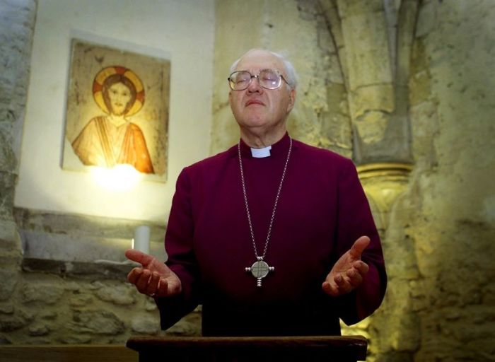 George Carey, the former Archbishop of Canterbury, leads a ceremony of prayer in the Crypt Chapel at his official residence in central London on Oct. 5, 2001.