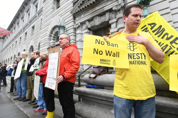 William Butkus joins about 12 protesters outside the 9th U.S. Circuit Court of Appeals courthouse in San Francisco, California, February 7, 2017, after the Court heard arguments regarding President Donald Trump's temporary travel ban on people from seven Muslim-majority countries.