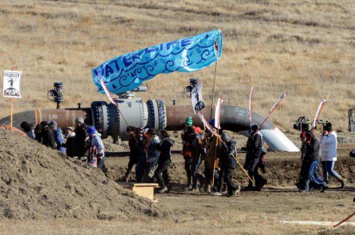 Protesters march along the pipeline route during a protest against the Dakota Access pipeline near the Standing Rock Indian Reservation in St. Anthony, North Dakota, U.S. November 11, 2016.
