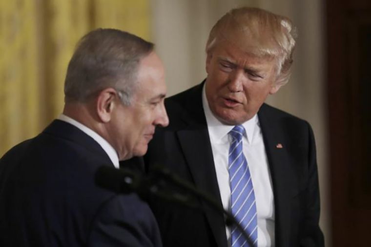 U.S. President Donald Trump (R) looks to Israeli Prime Minister Benjamin Netanyahu hold a joint news conference at the White House in Washington, February 15, 2017.