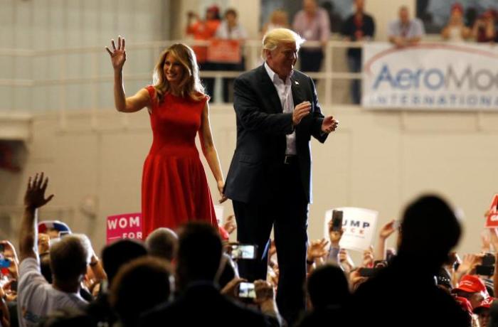 U.S. President Donald Trump and first lady Melania Trump acknowledge supporters during a 'Make America Great Again' rally at Orlando Melbourne International Airport in Melbourne, Florida, U.S. February 18, 2017.