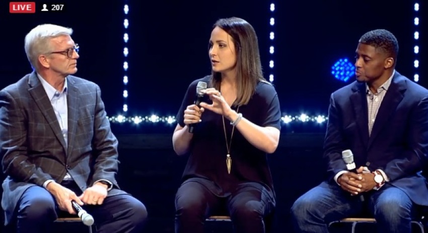 Former Louisiana State University soccer standout Mo Isom (M) speaks at the "Under Our Skin" forum on race and faith hosted at The Crossing Church in Tampa, Florida on Feb. 16, 2017. Isom is flanked by former NFL running back Warrick Dunn (R) and Detroit pastor J. Kevin Butcher (L)