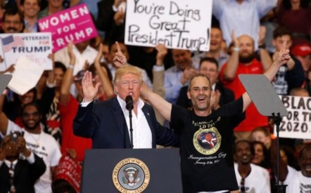 U.S. President Donald Trump invites a supporter onstage with him during a "Make America Great Again" rally in Melbourne, Florida, on February 18, 2017.