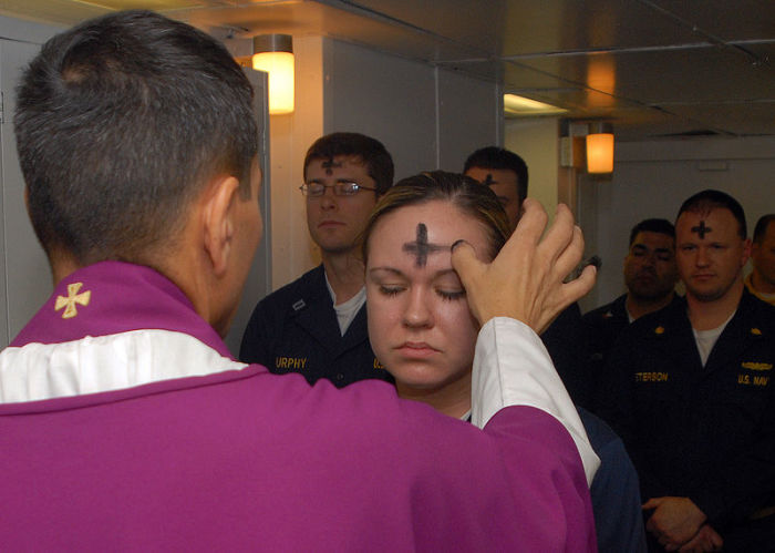 Electronics Technician 3rd Class Leila Tardieu receives the sacramental ashes during an Ash Wednesday in this undated photo.
