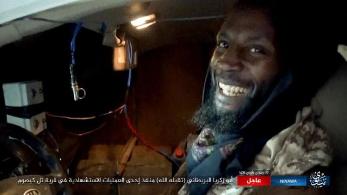 Still image shows British militant Jamal Udeen al-Harith smiling and seated inside a car with wires hanging off him at an unknown location, in this undated video taken from social media.