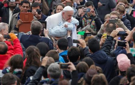 Pope Francis kisses a baby as he leads the weekly general audience in Saint Peter's Square at the Vatican February 22, 2017.