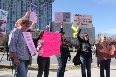 Anti-Trump protesters demonstrate outside the Gaylord National Resort and Convention Center at the same time in which President Donald Trump addressed a crowd of conservatives gathered for the annual Conservative Political Action Conference in Oxon Hill, Maryland on Feb. 24, 2017.