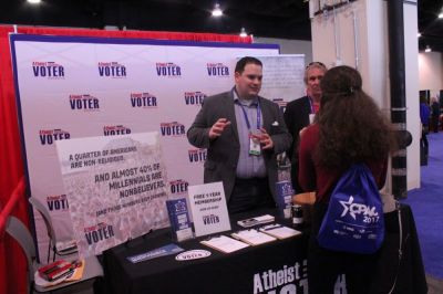 Atheist Voter's Nick Fish talks with an attendee of the annual Conservative Political Action Conference at the Gaylord National Resort and Convention Center in Oxon Hill, Maryland on Feb. 24, 2017.