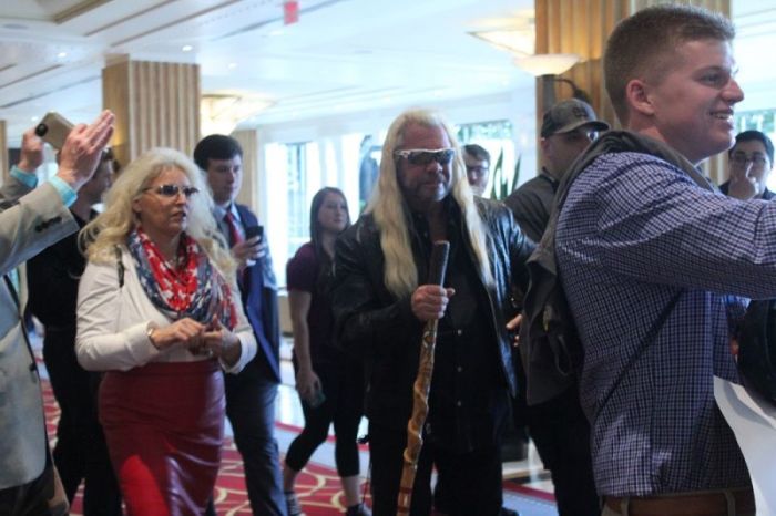 Duane 'Dog the Bounty Hunter' Chapman walks with his wife, Beth, as they are surrounded by fans at the Gaylord National Resort and Convention Center in Oxon Hill, Maryland, on February 24, 2017.