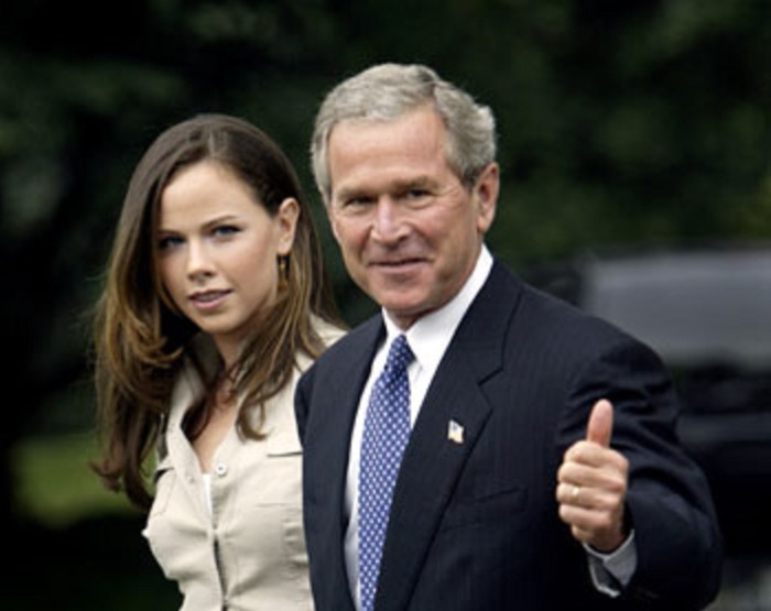 Former U.S. President George W. Bush and his daughter Barbara walk from the Marine One helicopter to Air Force One, July 13, 2004 at Andrews Air Force Base in Maryland, just outside Washington.