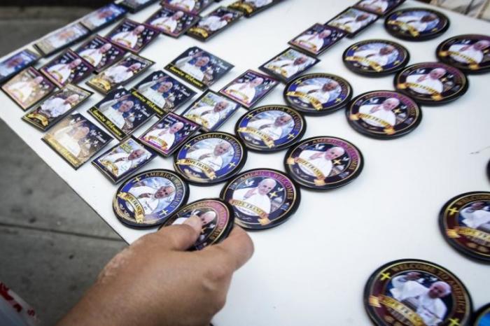 A person purchases a button in advance of Pope Francis' visit to the U.S. in New York, September 18, 2015.