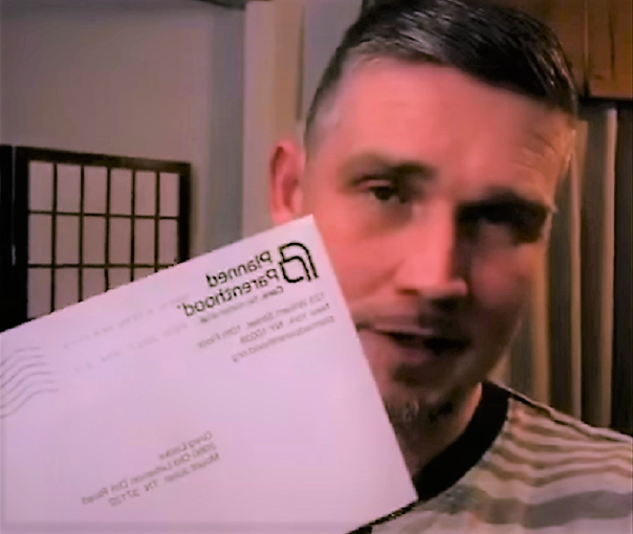 Pastor Greg Locke holds up a thank you letter from Planned Parenthood.