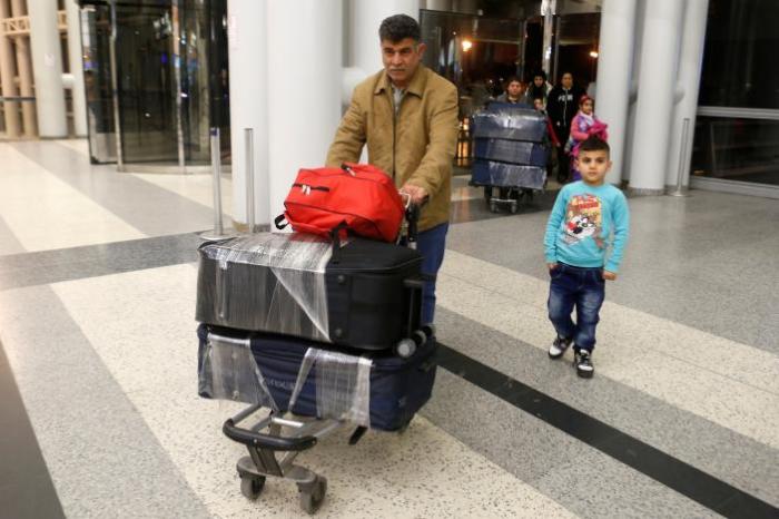 Nizar al-Qassab, an Iraqi Christian refugee from Mosul, pushes his family's luggage at Beirut international airport ahead of their travel to the United States, Lebanon February 8, 2017.