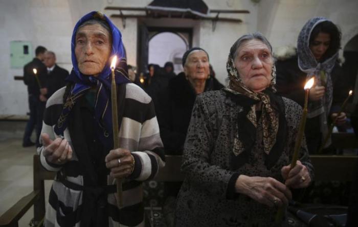 Syriac Christians from Turkey and Syria attend a mass at the Mort Shmuni Syriac Orthodox Church in the town of Midyat, in Mardin province of southeast Turkey in this February 2, 2014, file photo.
