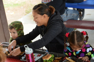 Pfc. Tawni Munford, microwave systems operator and maintainer with 86th Expeditionary Signal Battalion, enjoys lunch with her 5-year-old daughter and 4-year-old son, Aerion and Orion Munford, at the Better Opportunities for Single Parents' End of the Summer Bash, Sept. 8, at Biggs Park on Fort Bliss.