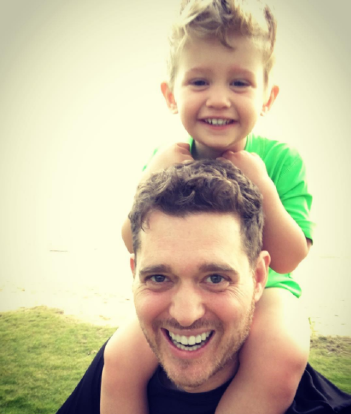 Michael Buble poses with his son Noah after vacation, 2016.