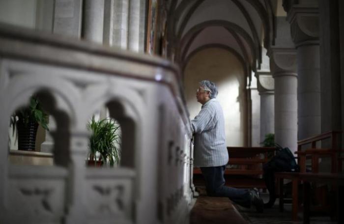 A woman prays at Sheshan Cathedral in the outskirts of Shanghai October 28, 2013.