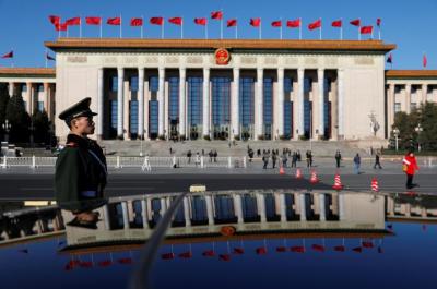 A paramilitary policeman stands guard in front of the Great Hall of the People at the Tiananmen Square in Beijing, China, March 12, 2017.