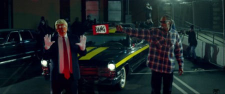 Raper Snoop Dogg aims a toy gun at a clown dressed like Donald Trump in the "BADBADNOTGOOD - Lavender" video ft. Kaytranada & Snoop, March 12, 2017