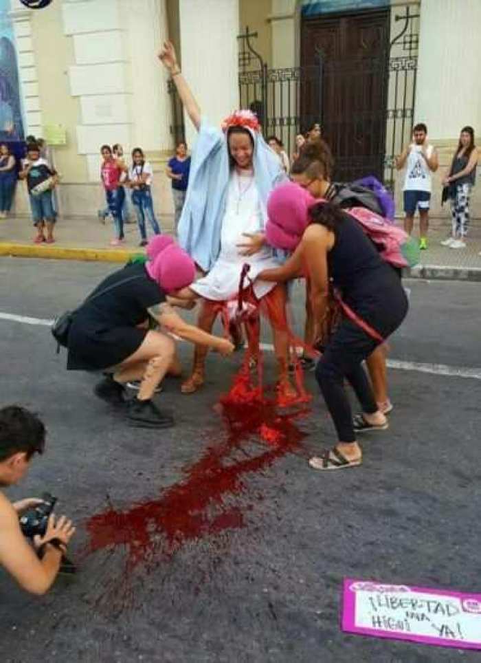 Feminists protesting outside the Roman Catholic cathedral on International Women's Day in Tucuman, Argentina, perform mock abortion of Jesus Christ on the Virgin Mary, March 8, 2017.