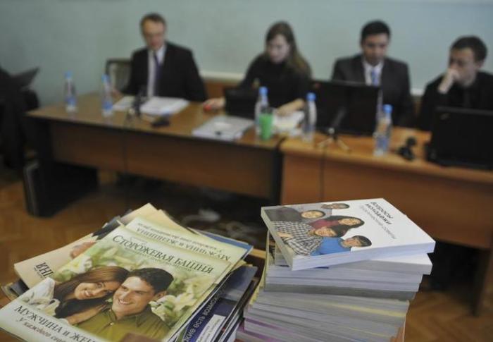 Stacks of booklets distributed by Alexander Kalistratov (L), the local leader of a Jehovah's Witnesses congregation, are seen during the court session in the Siberian town of Gorno-Altaysk, December 16, 2010.