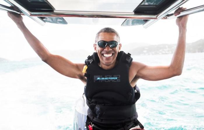 Obama sits on a boat during a kite surfing outing with British businessman Richard Branson during his holiday on Branson's Moskito island, in the British Virgin Islands.