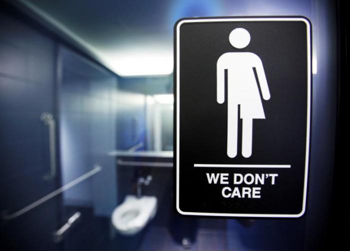 A sign protesting a recent North Carolina law restricting transgender bathroom access adorns the bathroom stalls at the 21C Museum Hotel in Durham, North Carolina May 3, 2016.