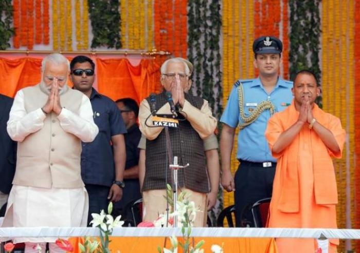 Prime Minister Narendra Modi (L), Uttar Pradesh governor Ram Naik (C) and Bharatiya Janata Party (BJP) leader Yogi Adityanath (R) greet a gathering before Adityanath takes an oath as the new Chief Minister of India's most populous state of Uttar Pradesh during a swearing-in ceremony in Lucknow, India, March 19, 2017.