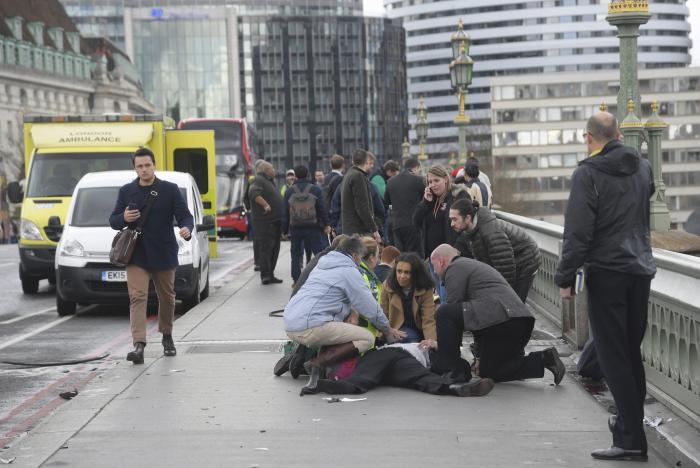 Injured people are assisted after an incident on Westminster Bridge in London, March 22, 2017.