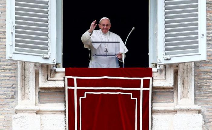 Pope Francis waves as he leads the Angelus prayer in Saint Peter's square at the Vatican March 5, 2017.