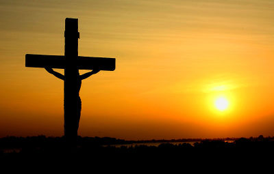 A silhouette of the image of the crucified Christ against a sunset in Batticaloa, Sri Lanka.
