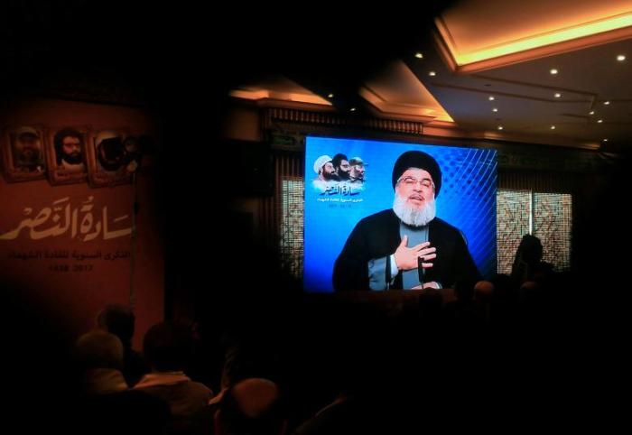 Lebanon's Hezbollah leader Sayyed Hassan Nasrallah addresses his supporters through a screen during a rally commemorating the annual Hezbollah Martyrs' Leaders Day in Jebshit village, southern Lebanon February 16, 2017.