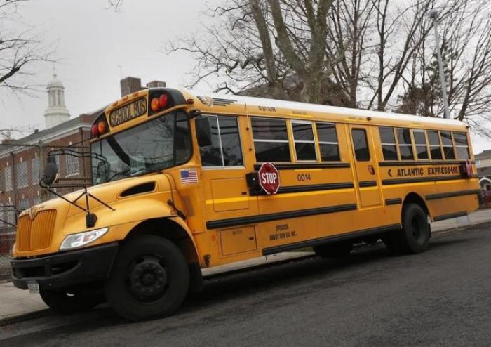 A school bus is seen parked in front of a school in the Queens borough of New York January 15, 2013.