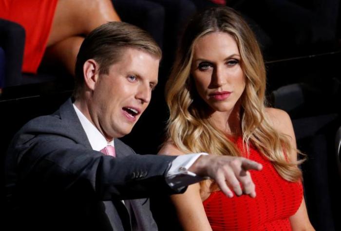 Donald Trump's son Eric Trump and his wife Lara Yunaska watch the proceedings during the third day of the Republican National Convention in Cleveland, Ohio, U.S., July 20, 2016.