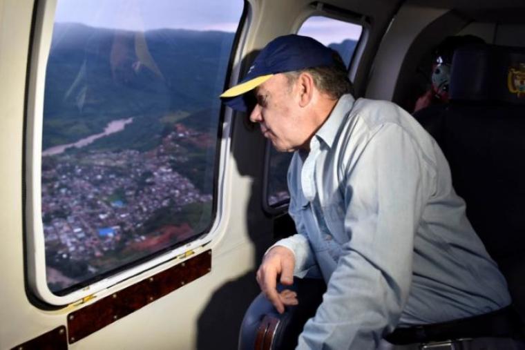 Colombia's President Juan Manuel Santos overflies a flooded area after heavy rains caused several rivers to overflow, pushing sediment and rocks into buildings and roads in Mocoa, Colombia, April 1, 2017.