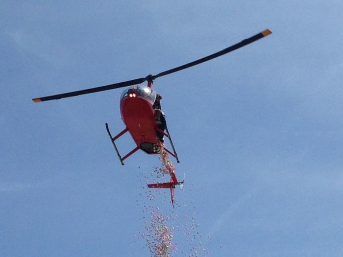 A helicopter drops thousands of Easter eggs for Element Church's annual Easter Egg Hunt at McNair Stadium in Forest City, North Carolina.