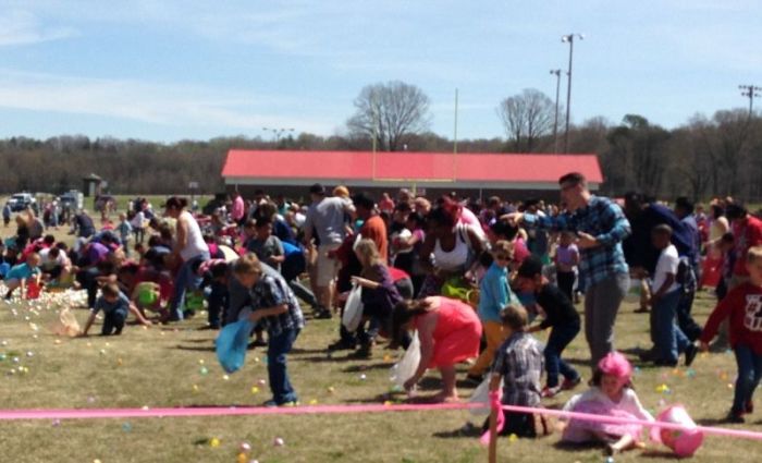 Children gather up some of the thousands of Easter eggs at Element Church's annual Easter Egg Hunt held at McNair Stadium in Forest City, North Carolina.