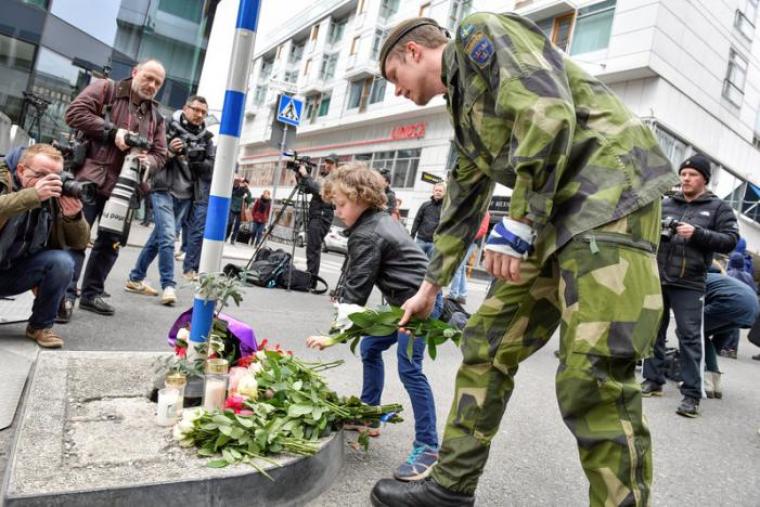 STOCKHOLM 2017-04-08 People laying flowers near the crime scene in central Stockholm the morning after a hijacked beer truck plowed into pedestrians on Drottninggatan and crashed into Ahlens department store on Friday, killing four people, injuring 15 others.