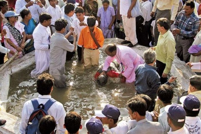 A Christian minister baptizes new Christian converts in Nagpur, India.
