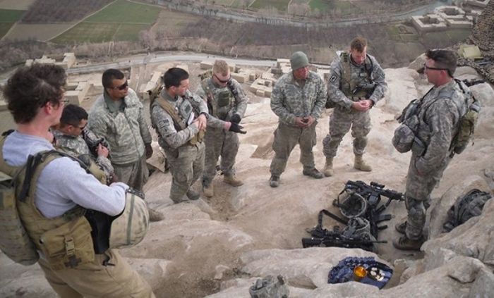 A U.S. Army chaplain leads soldiers in prayer while on overseas deployment.