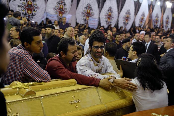 Relatives of victims react next to coffins arriving to the Coptic church that was bombed on Sunday in Tanta, Egypt, April 9, 2017.